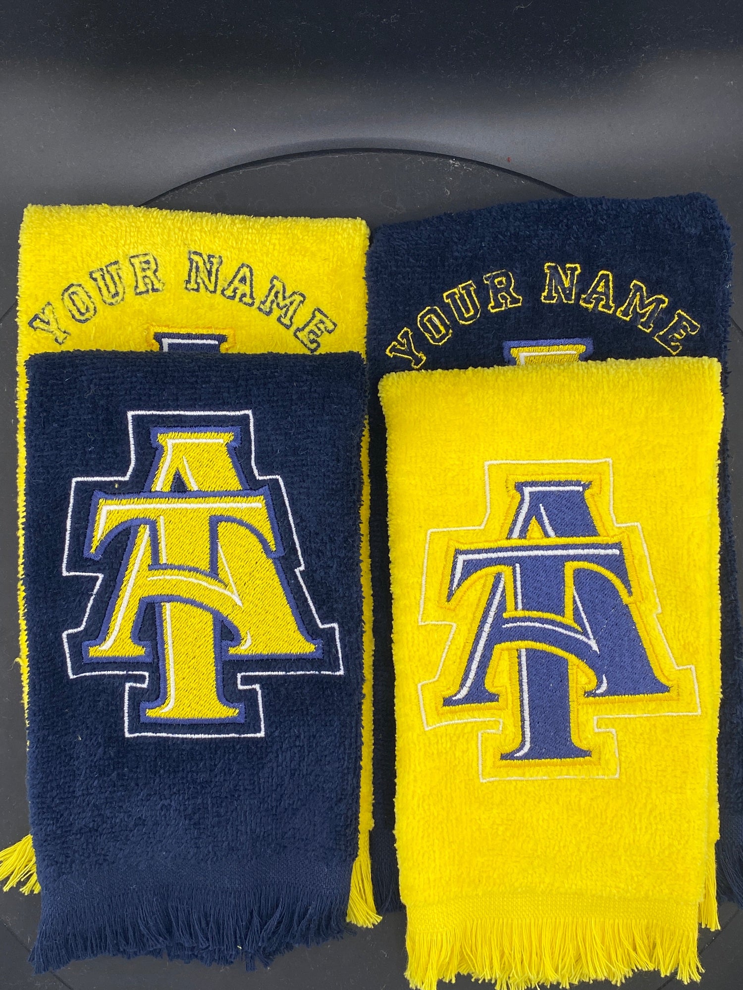 4 Leisure Luxe Towels in gold and navy representing North Carolina A&T State University - West & Remount Custom Apparel