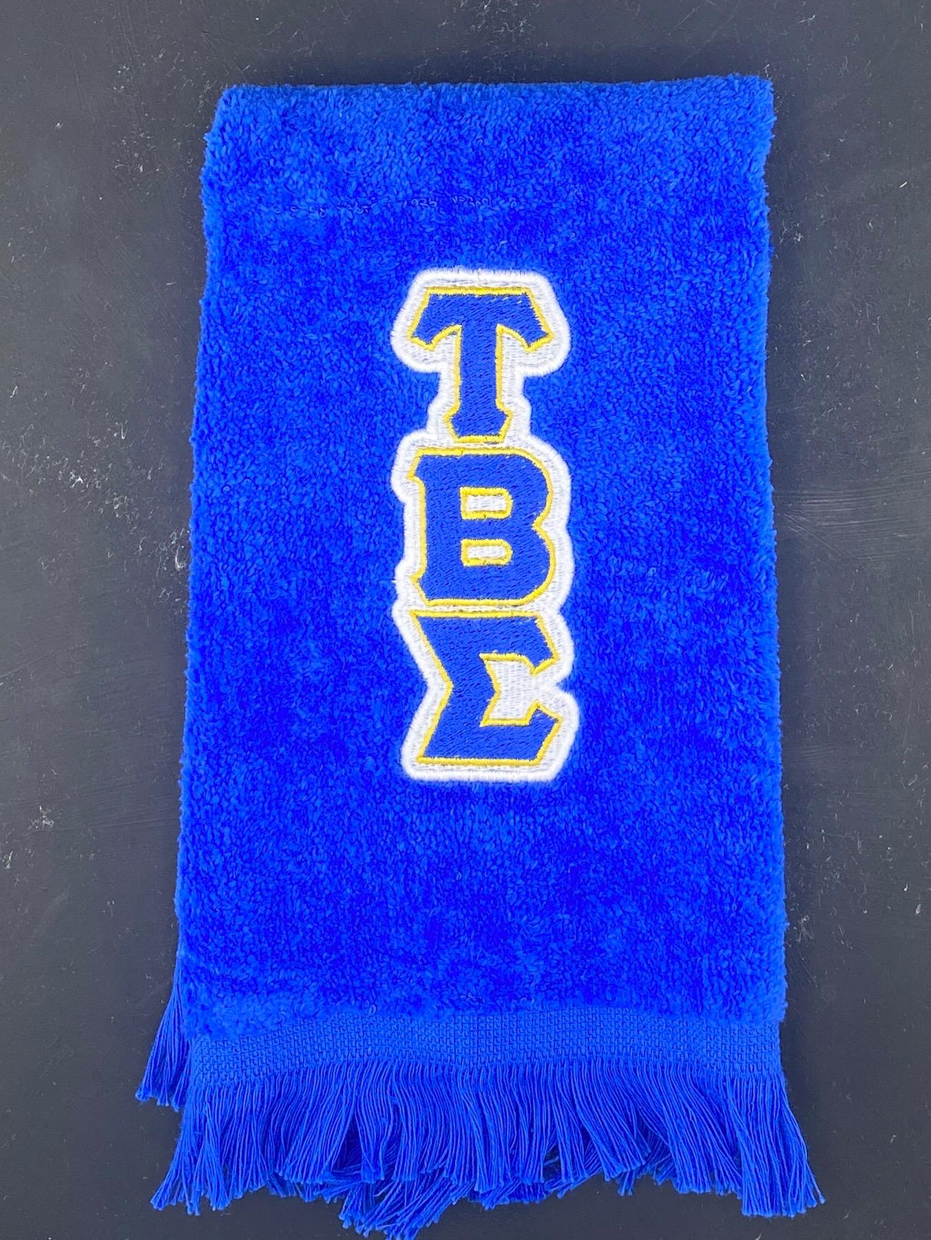 a blue stroll towel featuring the letters of Tau Beta Sigma National Honorary Band Sorority - West & Remount Custom Apparel
