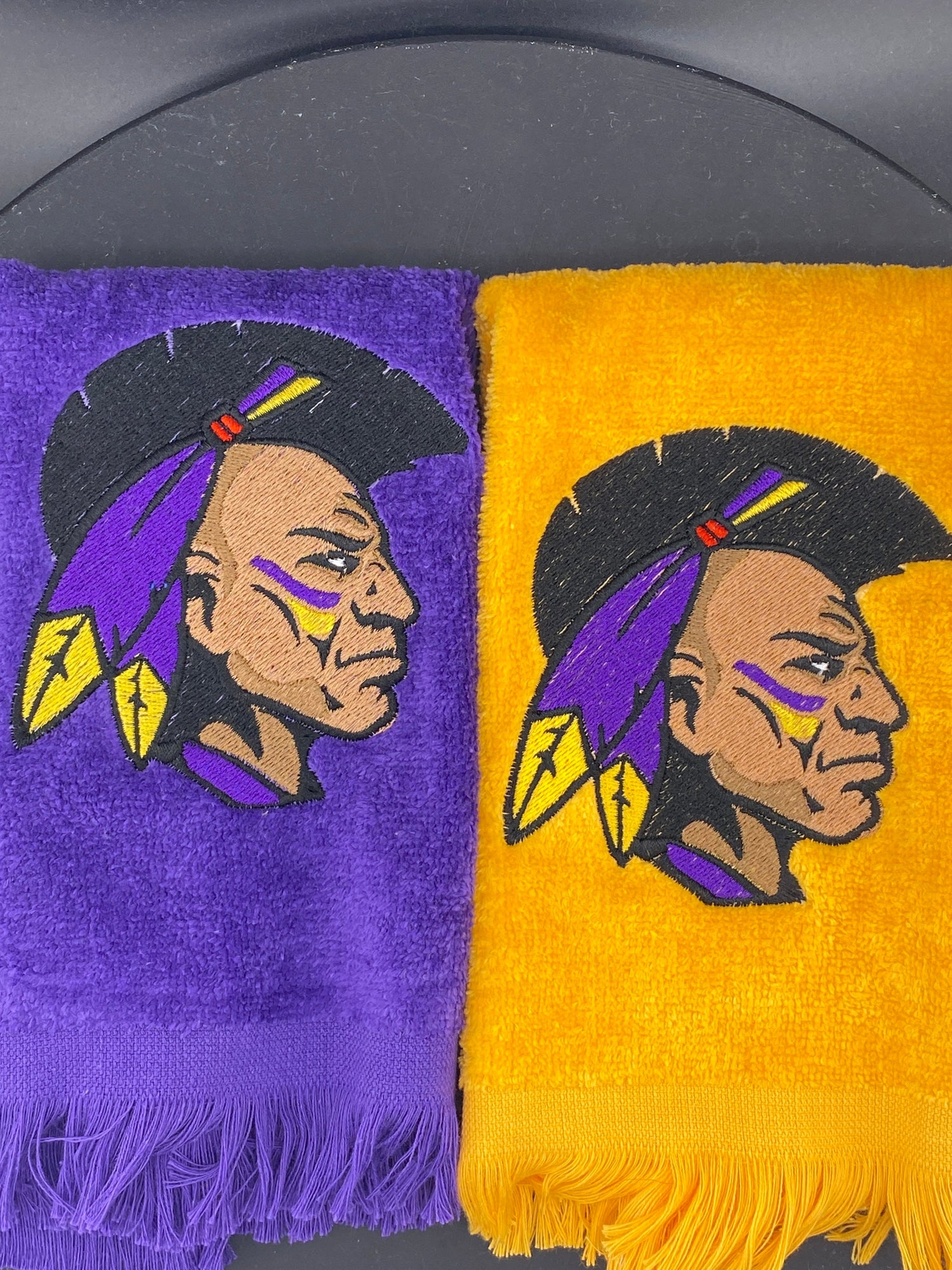 2 Leisure Luxe towels in Purple and Gold representing The Alcorn Collection - West & Remount Custom Apparel