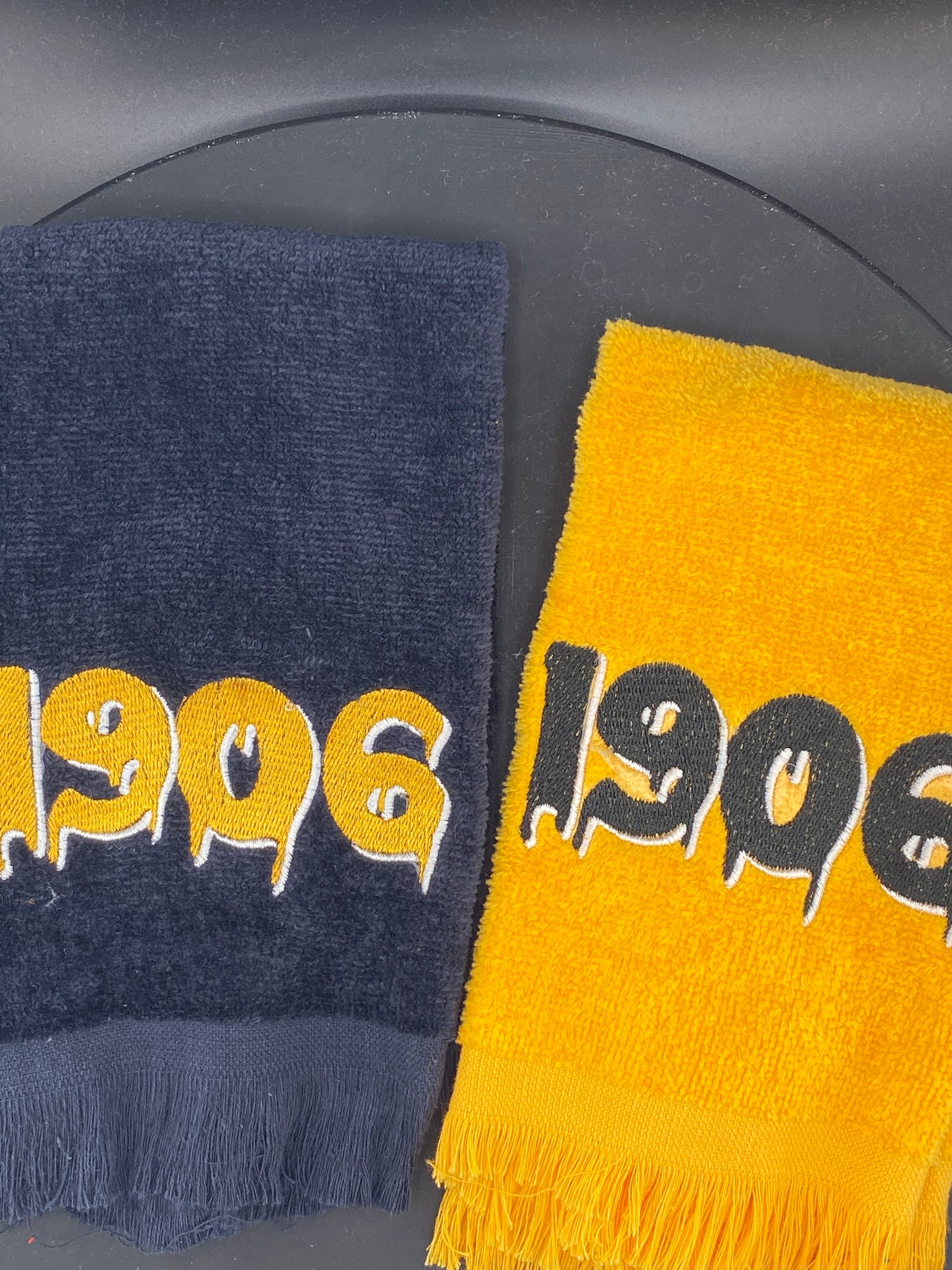 Two Stroll Towels with '1906' in black and gold. 